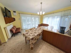 a living room with a table and a kitchen at Holiday home in Balatonlelle 53637 in Balatonlelle