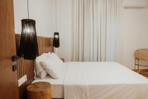 Postel nebo postele na pokoji v ubytování iKu Urban Apartment