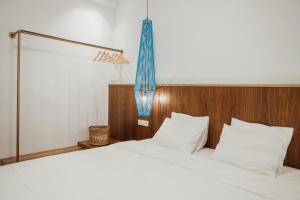 Postel nebo postele na pokoji v ubytování iKu Urban Apartment