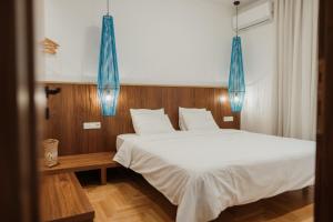 Postel nebo postele na pokoji v ubytování iKu Urban Apartment