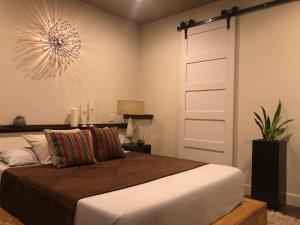 a bedroom with a large bed with a white door at Beautiful Cottage, hot tub, in great neighborhood in San Francisco