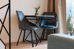 a table and two chairs next to a table at Bed & Breakfast De Pol in Doetinchem