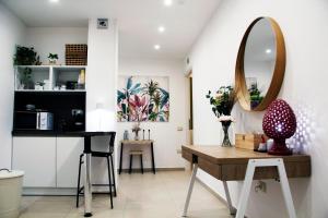 a dining room with a table and a mirror at Nina Suites in Salerno