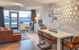 a living room with a table and chairs and a couch at Vakantiewoning Bruinisse aan Jachthaven Zeeland, VP012 in Bruinisse