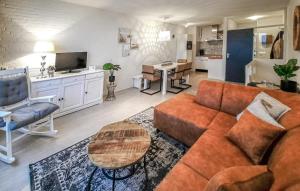 a living room with a couch and a table at Vakantiewoning Bruinisse aan Jachthaven Zeeland, VP012 in Bruinisse