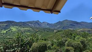 a view of the mountains from a house at Kitnet Sol e Lua in Caparaó Velho