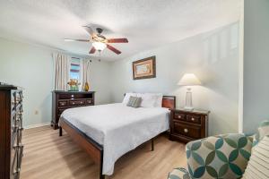 a bedroom with a bed and a ceiling fan at Sundial Unit D1 in Gulf Shores