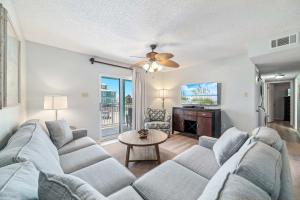 a living room with a couch and a tv at Sundial Unit D1 in Gulf Shores