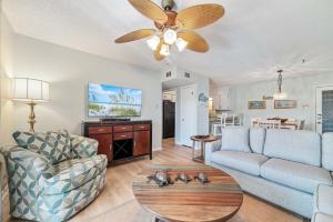 a living room with a couch and a ceiling fan at Sundial Unit D1 in Gulf Shores +28 photos