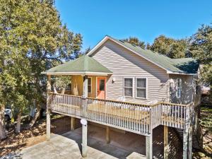 a house with a large deck with a porch at Mins to Beach Hot Tub Projector Shuffleboard in Kill Devil Hills