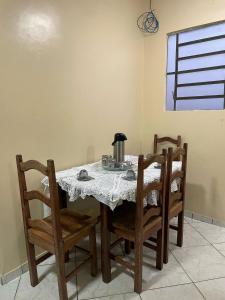 a dining room table with chairs and a coffee maker on it at Terraço sol e lua in Belém