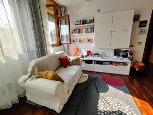 a living room with a white couch and a table at Premier Apartment Milano in Milan