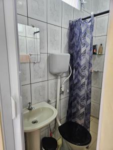 a bathroom with a sink and a toilet and a shower at Terraço sol e lua in Belém