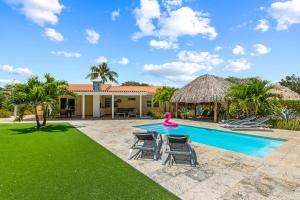 a swimming pool with a pink flamingo in a backyard at Kas di Rosa Curacao luxurious holiday home in Grote Berg