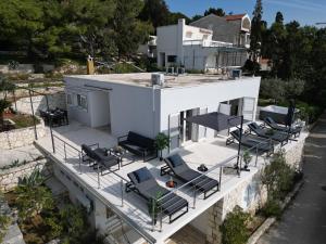 an aerial view of a house with chairs on a balcony at Hvar Dream View Penthouse with Hot Tub in Hvar