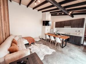a living room with a couch and a table at Apartamento campestre 2 dormitorios con terraza in Puerto Varas +16 photos