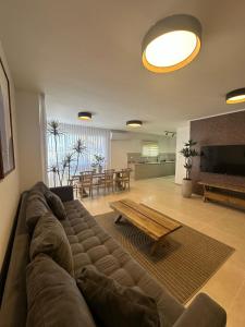 a living room with a large couch and a table at Ocean view - מול הים in Nahariyya