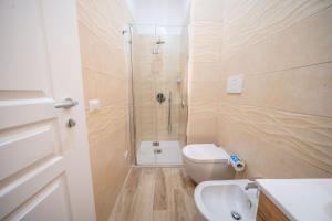 a bathroom with a shower and a toilet and a sink at Masseria Agata in Conversano +61 photos