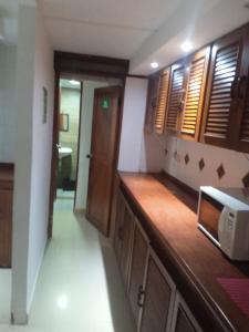 a kitchen with a counter with a microwave at Casa Emmalana in Santa Marta +10 photos