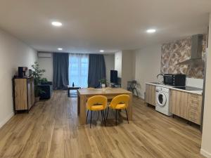 a kitchen and dining room with a table and yellow chairs at Alicante 20 in Alicante