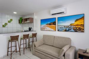 a living room with a couch and three pictures on the wall at Villa Park Hotel in Natal
