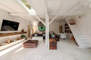 a living room with a couch and a staircase at Stilhaus 1730 in Königsbach Stein