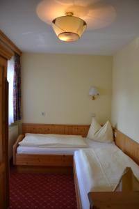 a bedroom with two beds and a light fixture at Holiday-Appartements in Flachau