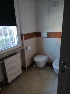 a small bathroom with a toilet and a sink at APPARTAMENTO LAKE GARDA ibiscus di Francia in Desenzano del Garda +25 photos
