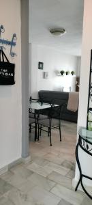 a living room with a table and a piano at Apartamento Danubio in El Puerto de Santa María +7 photos