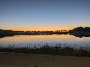 a body of water with a sunset in the background at Miniloft Baiona COM I in Baiona +2 photos