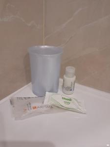 a pile of toothbrushes and a cup on a counter at La Petite Maison in Naples
