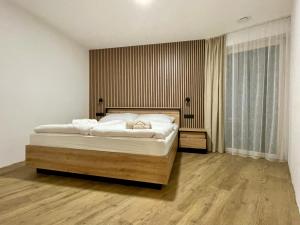 a bedroom with a large bed with white sheets at Apartmány nora - Příchovice in Kořenov +32 photos