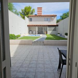 a view of a house with a patio and a yard at Lamadrid Lodge in Mendoza +31 photos
