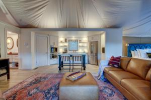 a living room with a couch and a table at The Covery the Wren House a luxury African tent retreat on stocked bass pond in Hot Springs +13 photos