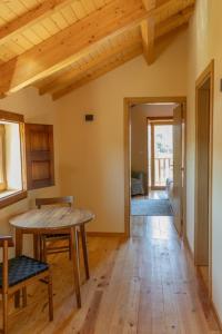 a living room with a wooden table and a dining room at Casa de Vilarinho in Vilarinho de Cotas