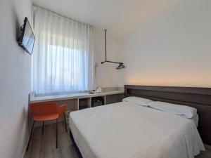 Postel nebo postele na pokoji v ubytování Hotel Piccolo