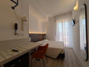 Postel nebo postele na pokoji v ubytování Hotel Piccolo