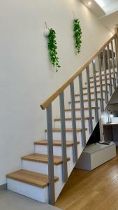a staircase with green plants on the wall at BeCO Moscova District Loft in Milan +19 photos