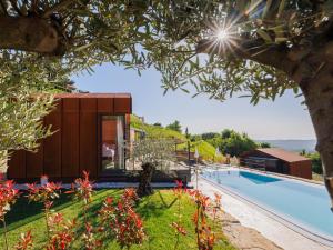 a villa with a pool and a house at Wine Paradise - Glamping resort in Marezige