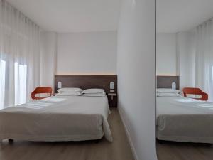 Postel nebo postele na pokoji v ubytování Hotel Piccolo