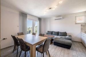 a living room with a table and a couch at Vila Nina - Apartment Valentina in Vinišće +15 photos