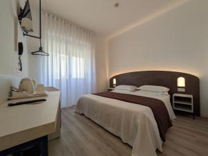 Postel nebo postele na pokoji v ubytování Hotel Piccolo
