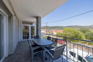 a balcony with a table and chairs on it at Vila Nina - Apartment Valentina in Vinišće