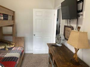 a bedroom with a bed and a desk with a television at 51 The Anchor in Centre
