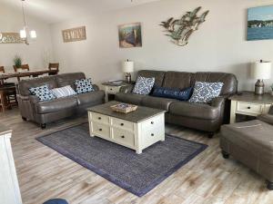 a living room with a leather couch and a coffee table at 51 The Anchor in Centre +19 photos