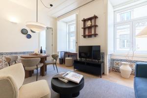 a living room with a couch and a table at Ando Living - Santa Justa 79 House in Lisbon