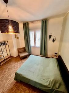 a bedroom with a bed and a window with green curtains at La Teranga in Imola +8 photos