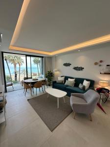 a living room with a blue couch and a table at Apartamento LaViu 2B by Croma in Estepona