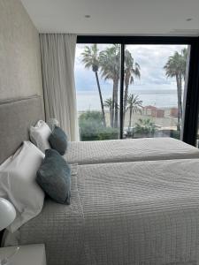 a bedroom with a bed with a view of the ocean at Apartamento LaViu 2B by Croma in Estepona