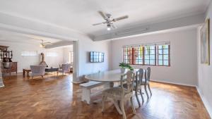 a dining room and living room with a table and chairs at The Famous Bokaap Villa in Cape Town